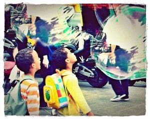 Children seeing large bubbles for the first time in Paris, France.